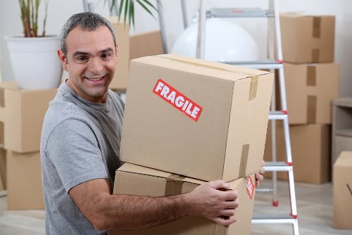 Commercial moving team organizing packed boxes and office items