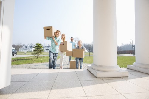 Trained movers using PPE while handling items carefully