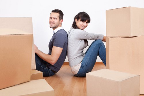 Professional movers loading household items into a van