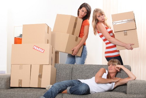 Team organising furniture and workstations for an office relocation