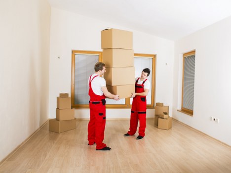 Packed boxes and furniture being loaded into a van