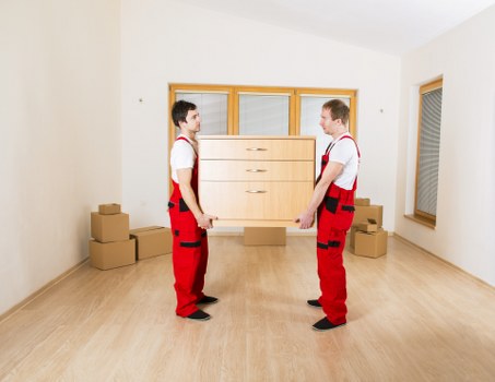 Furniture and boxes being carefully loaded into a van